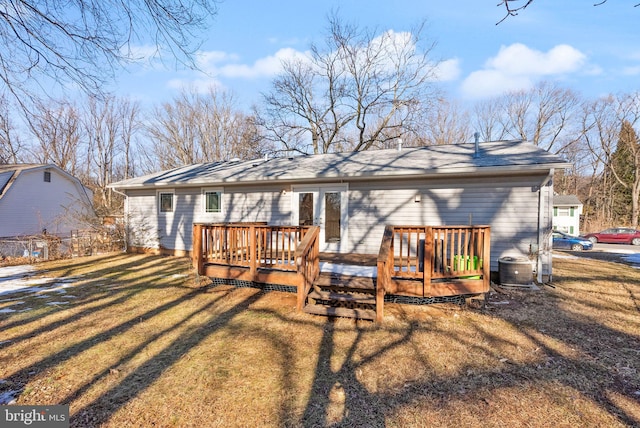 back of property featuring a yard and a deck