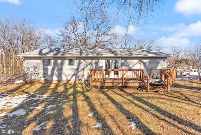 rear view of property with a wooden deck and a yard