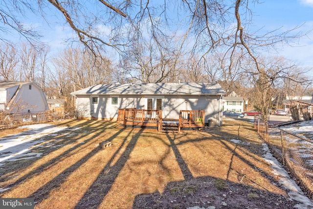 view of front of home with a wooden deck and a front yard