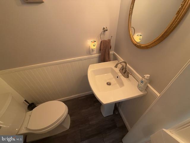 bathroom featuring sink, toilet, and hardwood / wood-style floors