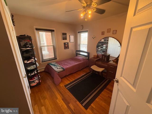 bedroom with ceiling fan and hardwood / wood-style floors