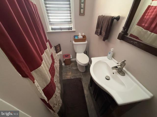 bathroom featuring tile patterned flooring, vanity, toilet, and a shower with shower curtain