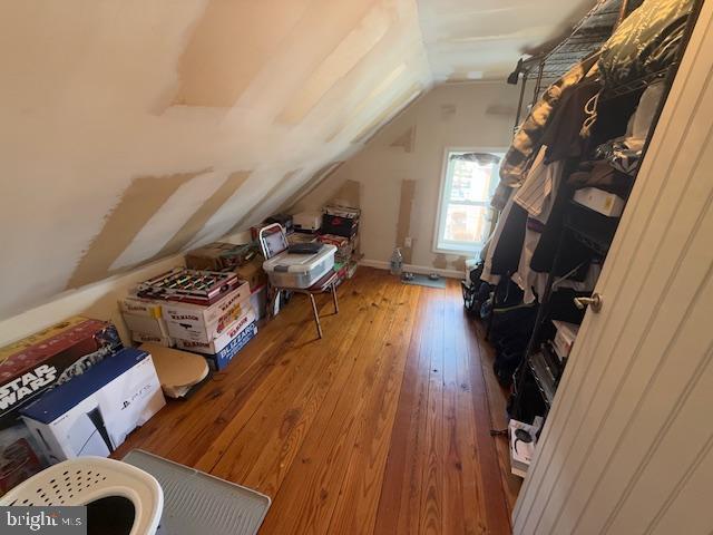 bonus room featuring lofted ceiling and wood-type flooring