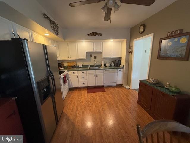 kitchen with sink, white appliances, light wood-type flooring, ceiling fan, and white cabinets