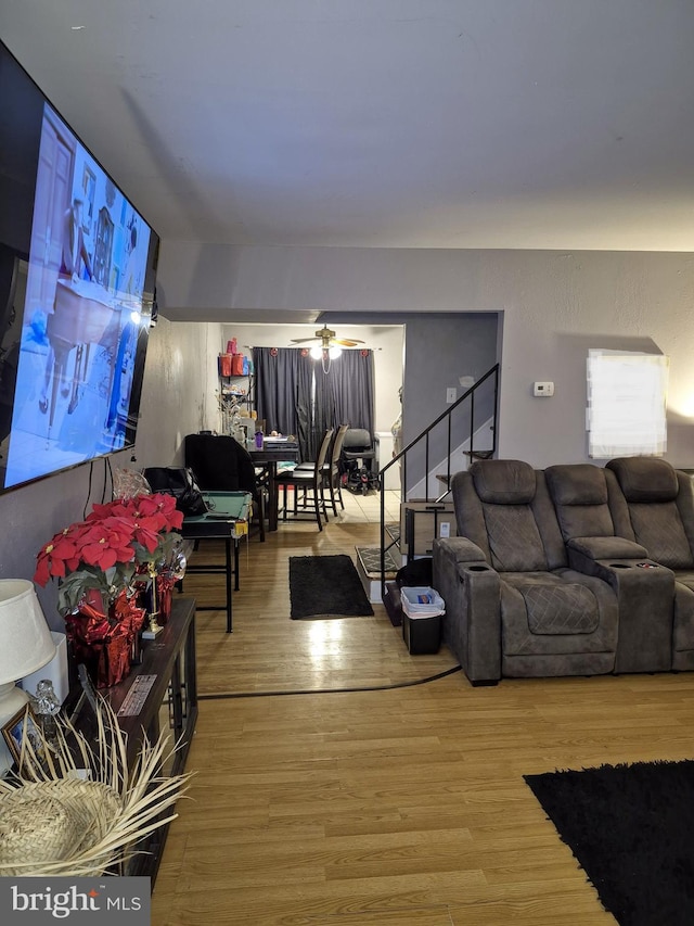 living room featuring hardwood / wood-style flooring and ceiling fan