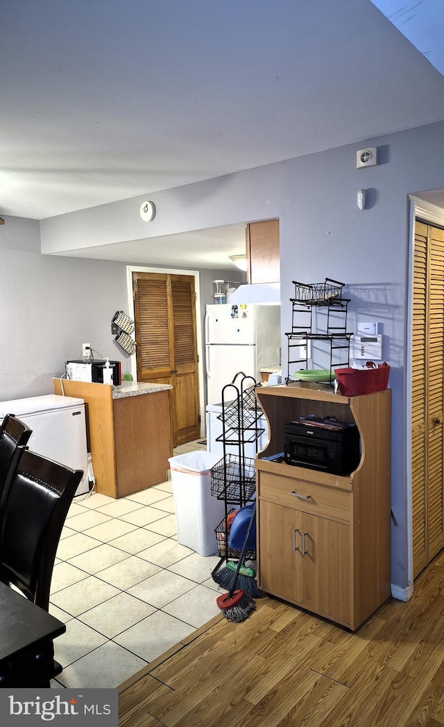 kitchen featuring fridge, light hardwood / wood-style floors, and white fridge