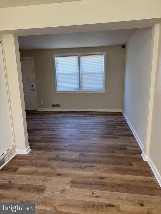 spare room with dark hardwood / wood-style flooring