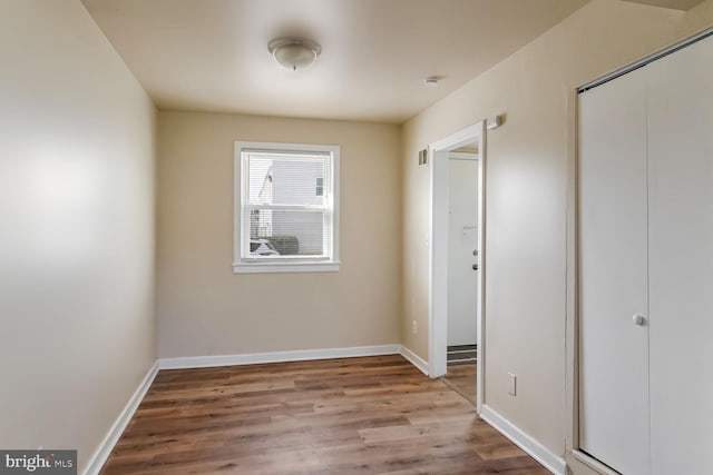 unfurnished bedroom featuring a closet and light hardwood / wood-style flooring