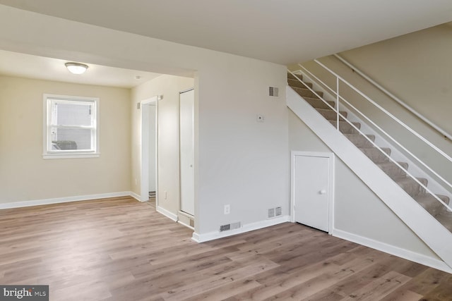 unfurnished room with hardwood / wood-style floors