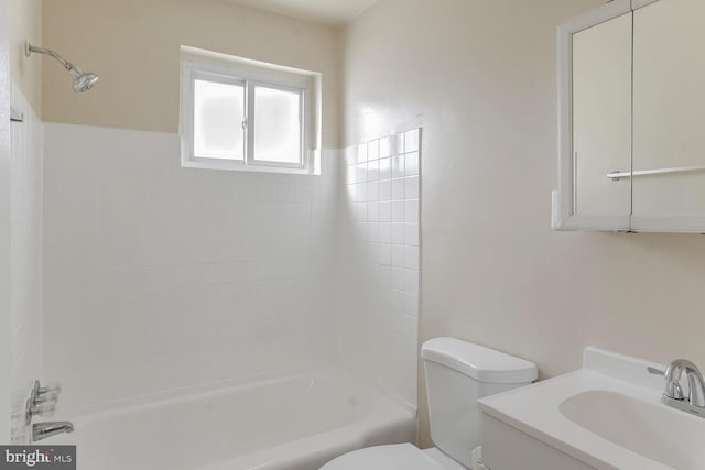 full bathroom featuring washtub / shower combination, vanity, and toilet