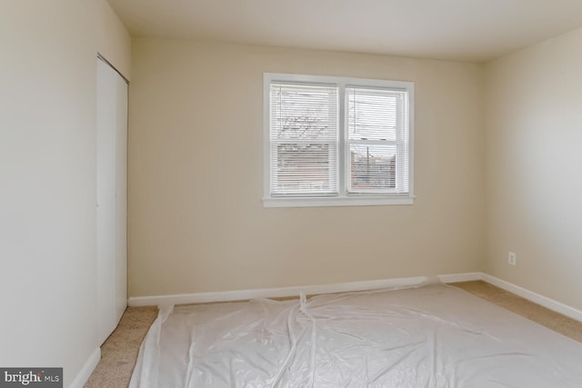 unfurnished room with light carpet