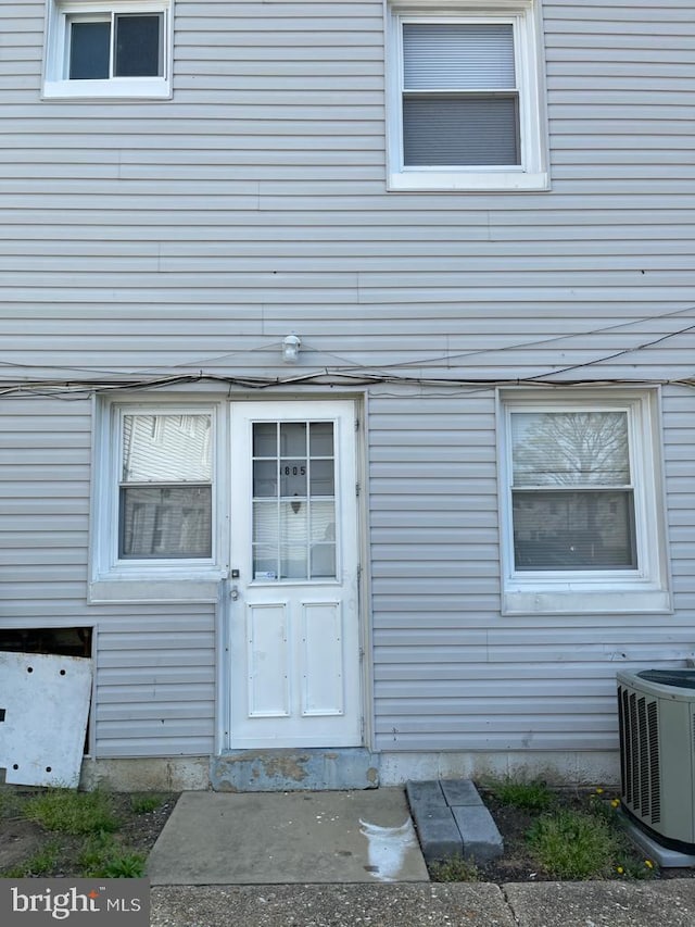 property entrance featuring central AC unit