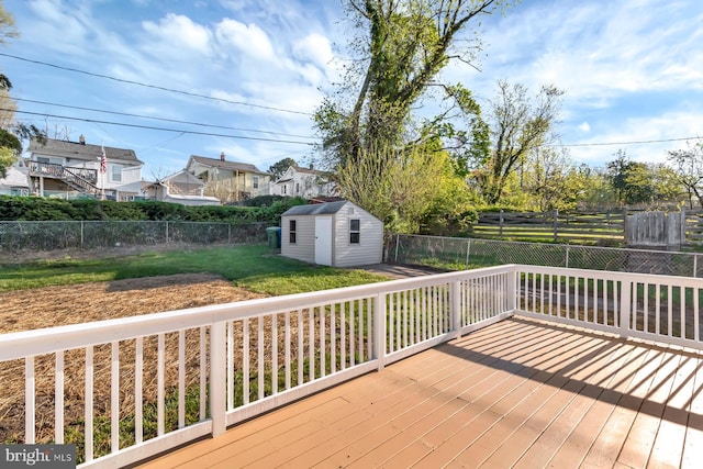 deck featuring a fenced backyard, an outdoor structure, and a storage shed