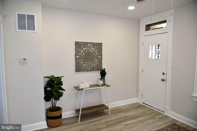 foyer entrance featuring recessed lighting, wood finished floors, visible vents, and baseboards