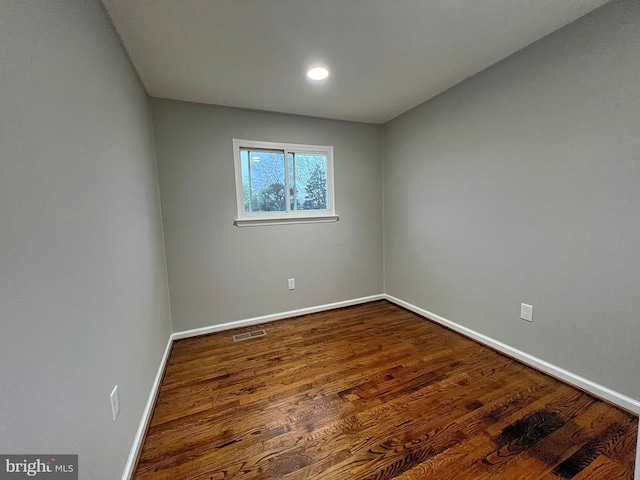 spare room with hardwood / wood-style floors