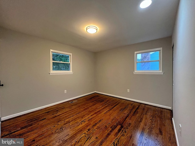 unfurnished room featuring dark hardwood / wood-style flooring