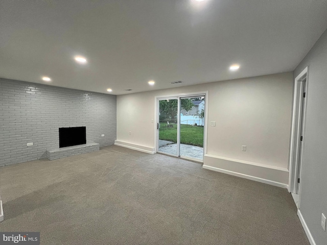 unfurnished living room featuring a fireplace and carpet flooring