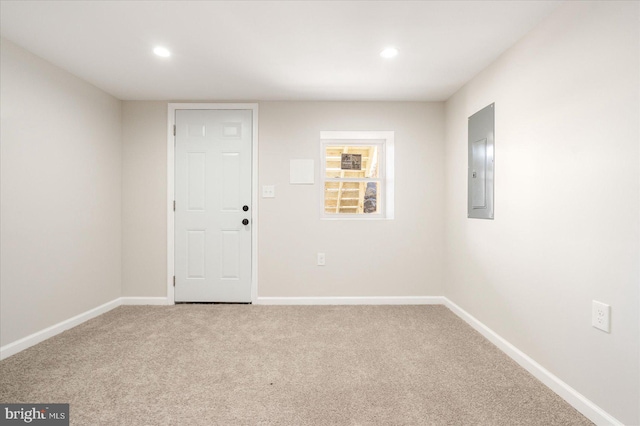 carpeted spare room featuring electric panel