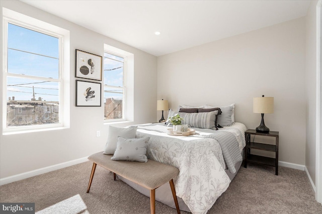 bedroom with multiple windows and carpet floors