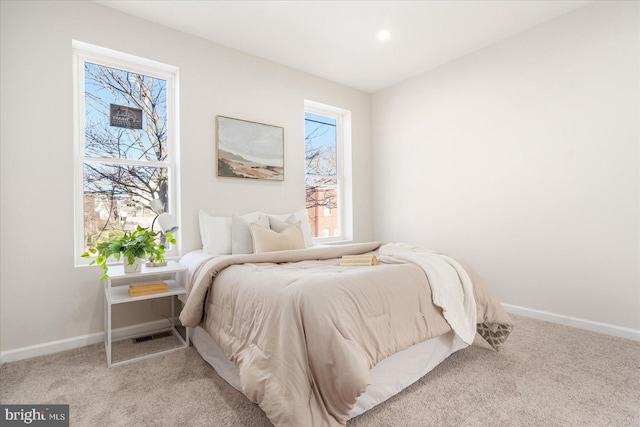 bedroom featuring light carpet