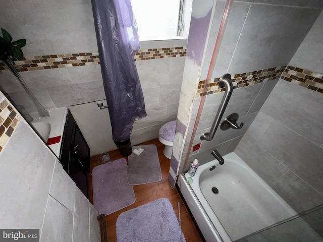 bathroom featuring tile walls and shower / bath combo with shower curtain