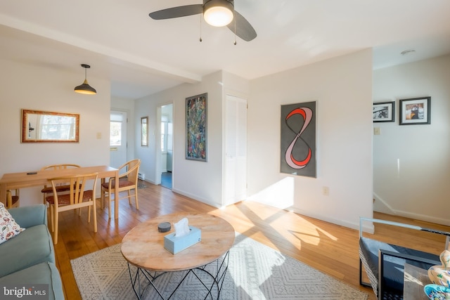 living room featuring ceiling fan and light hardwood / wood-style flooring