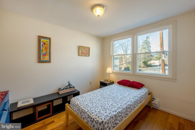 bedroom with hardwood / wood-style flooring