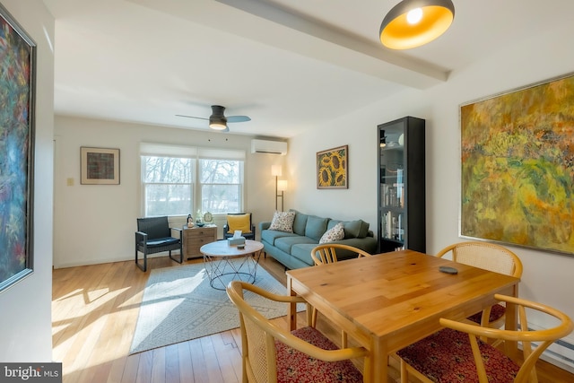 dining room featuring beamed ceiling, ceiling fan, light hardwood / wood-style floors, and an AC wall unit