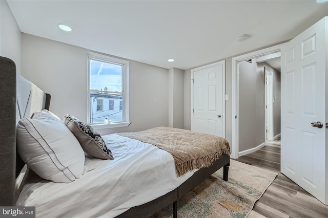 bedroom with dark wood-type flooring