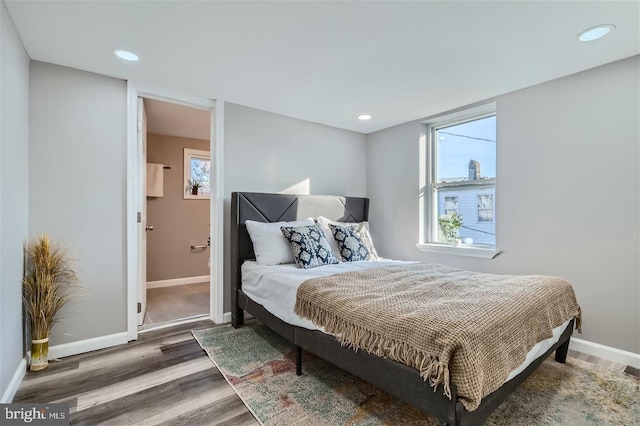 bedroom with dark wood-type flooring and ensuite bathroom