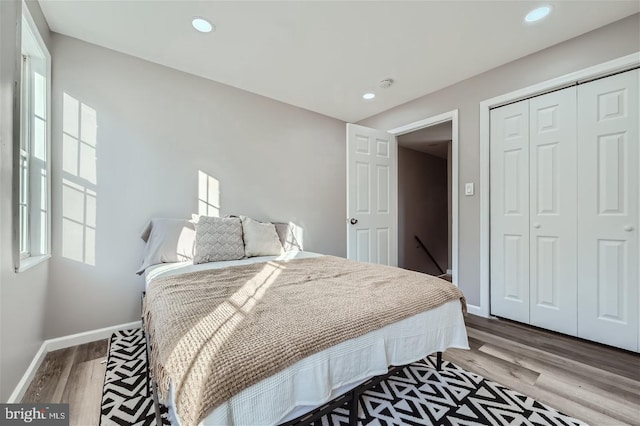 bedroom featuring light wood-type flooring and a closet