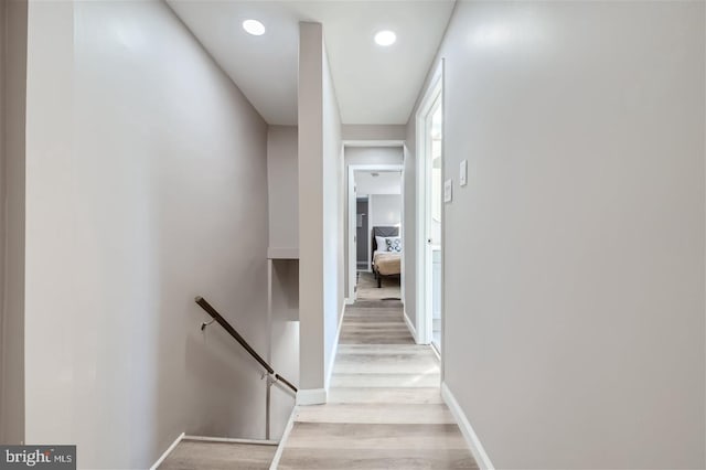 corridor with light hardwood / wood-style floors