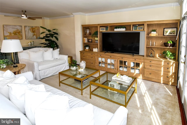 living room with ceiling fan and ornamental molding