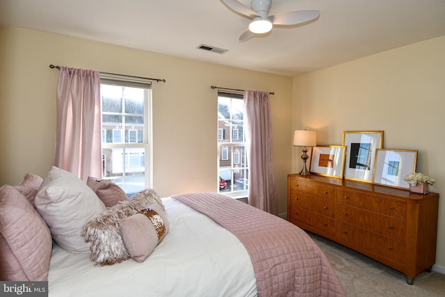 bedroom featuring multiple windows and light colored carpet