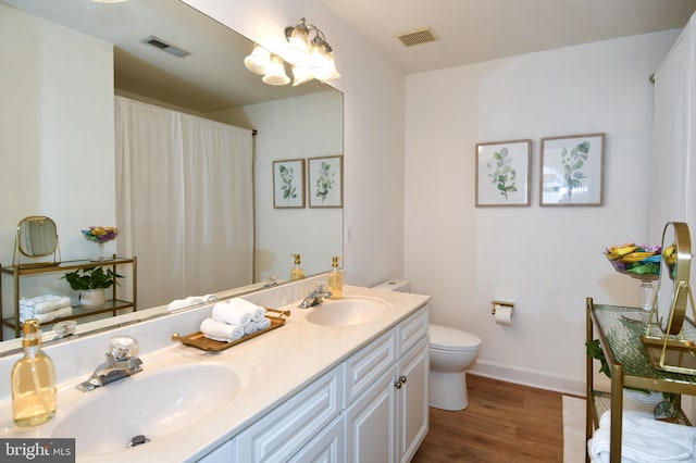 bathroom featuring hardwood / wood-style flooring, vanity, and toilet