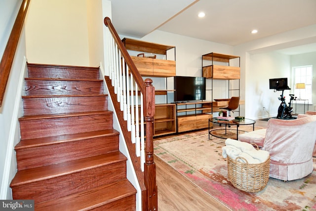 staircase with hardwood / wood-style flooring