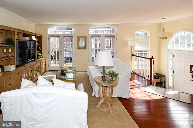 living room featuring ornamental molding, dark hardwood / wood-style flooring, and french doors