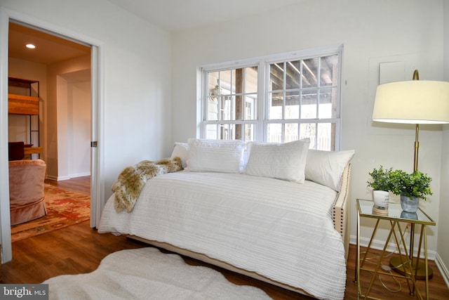 bedroom with dark wood-type flooring