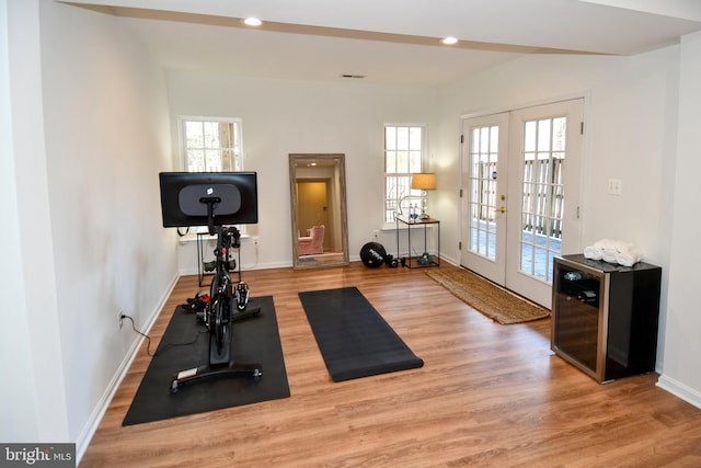 exercise room with french doors and wood-type flooring