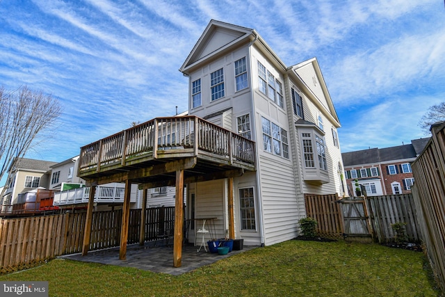 rear view of house with a yard, a patio area, and a deck