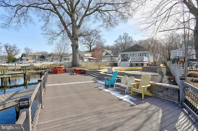 view of dock with a deck with water view