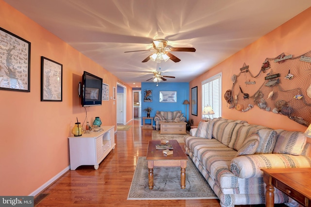 living room featuring hardwood / wood-style flooring and ceiling fan