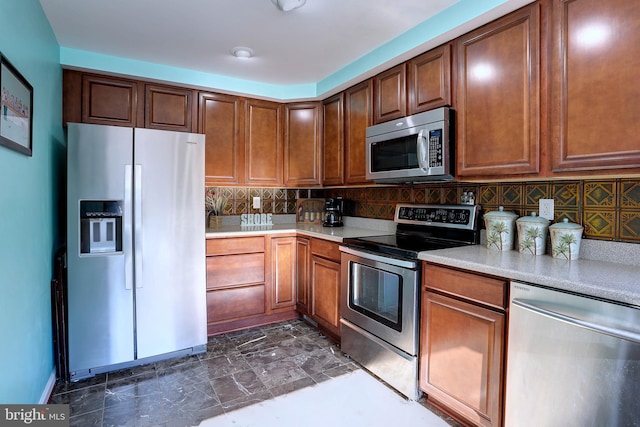 kitchen with appliances with stainless steel finishes and decorative backsplash