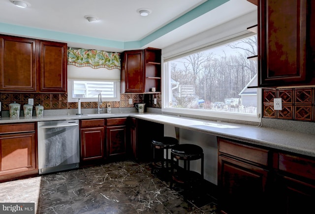 kitchen with tasteful backsplash, sink, and stainless steel dishwasher