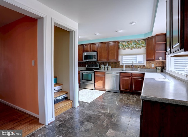 kitchen with sink, backsplash, and appliances with stainless steel finishes