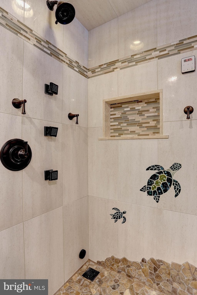 bathroom with tiled shower