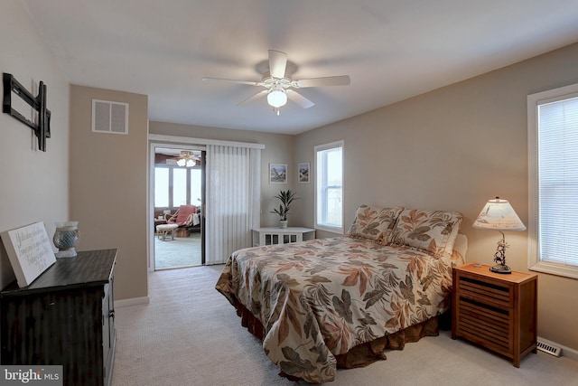 bedroom featuring light carpet and ceiling fan