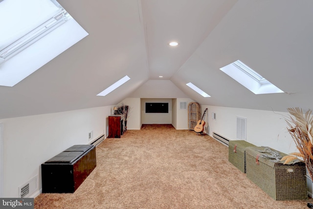 bonus room with a baseboard heating unit, vaulted ceiling, and light colored carpet