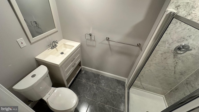 bathroom featuring vanity, toilet, and a tile shower