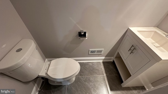 bathroom featuring vanity and toilet